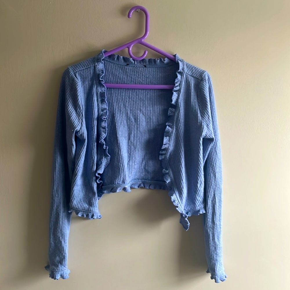 Small Shirt. Comes together with one button in the front. Good Condition